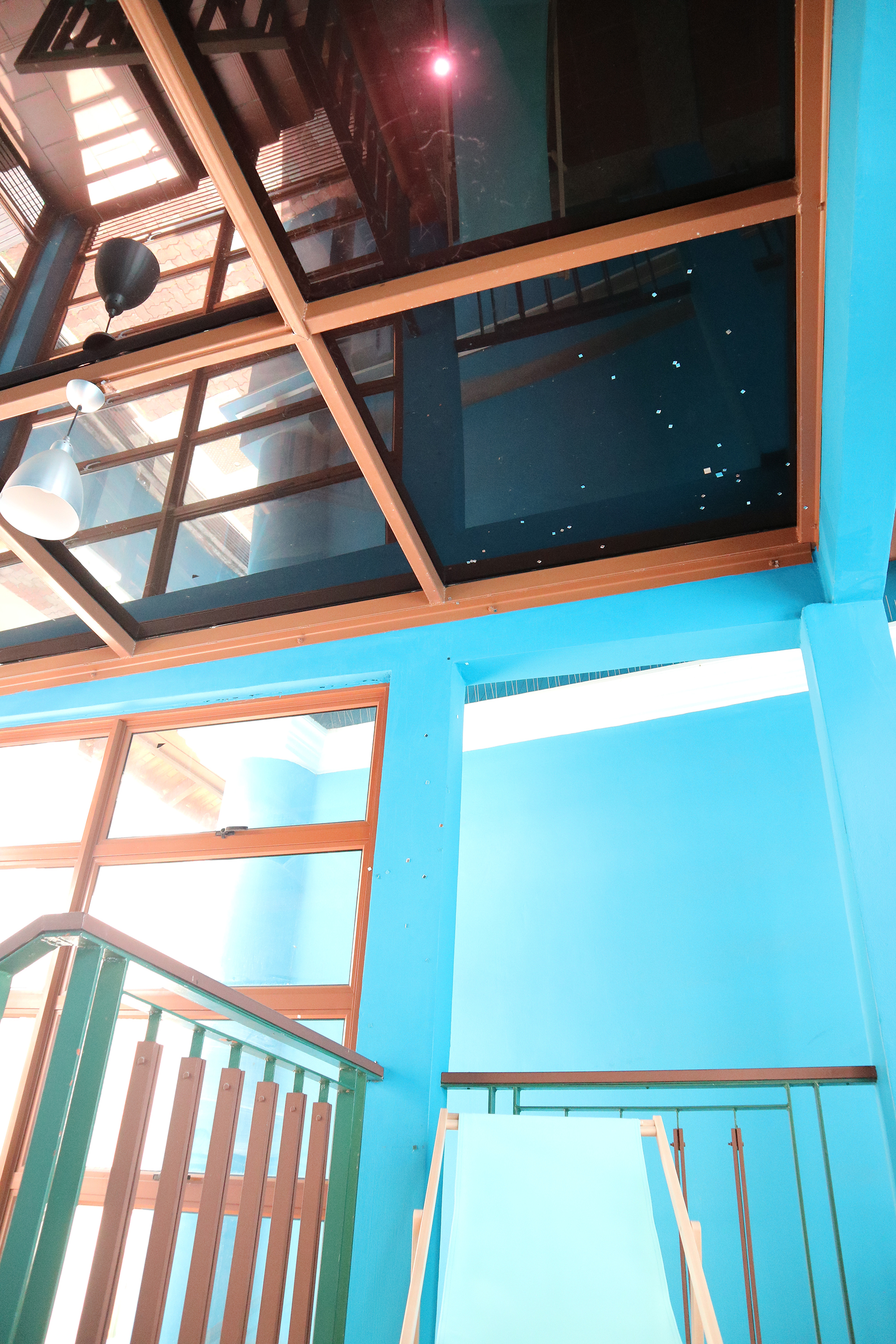 An image of the top of the stairwell where an object resembling a blue deck chair can be seen.