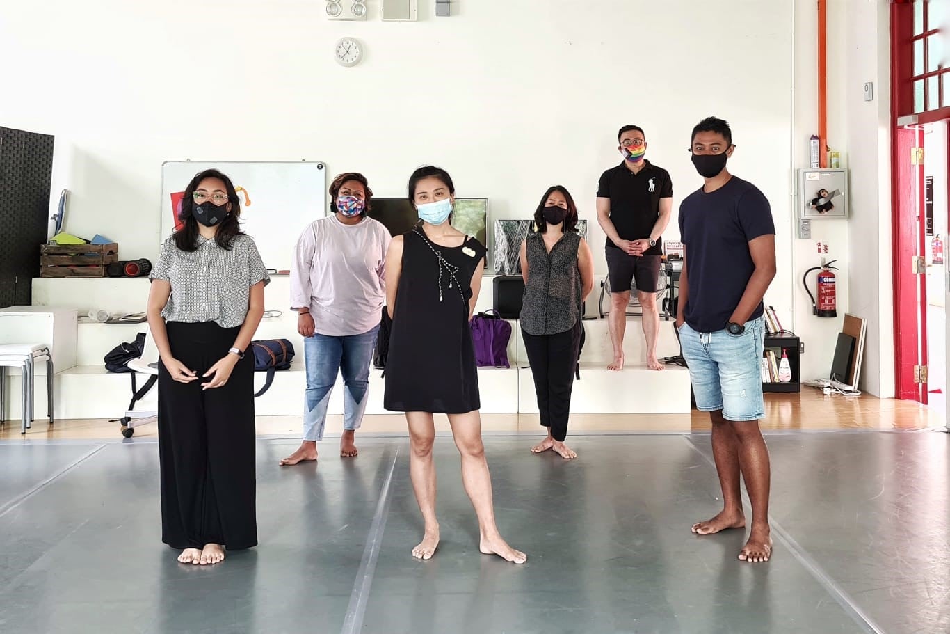 6 people standing in a well light studio, spaced apart and facing front. 6 people standing in a well light studio, spaced apart and facing front.