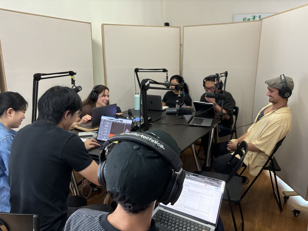 A group of people seated around a table with microphones in front of them.